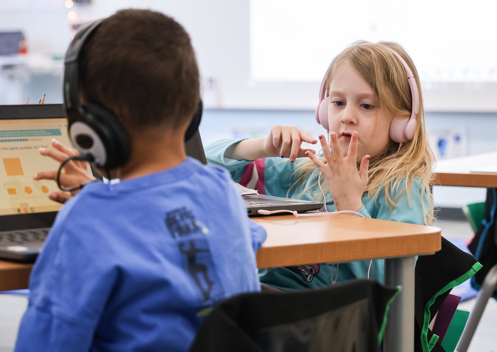 Avery Affourtit, a kindergarten student at Dayton Regional STEM Elementary School, counts on her fingers while doing a practice assignment on her computer on Tuesday, Jan. 20. The school opened a new elementary building the first week of the month. The new building is located just south of the combined middle and high school building. BRYANT BILLING/STAFF