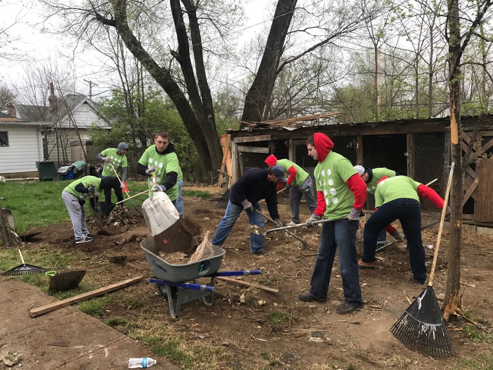 UD football players on Sturday clear out brush in an overgrown alley between Hopeland and Cincinnati streets Saturday. Tom Archdeacon/STAFF