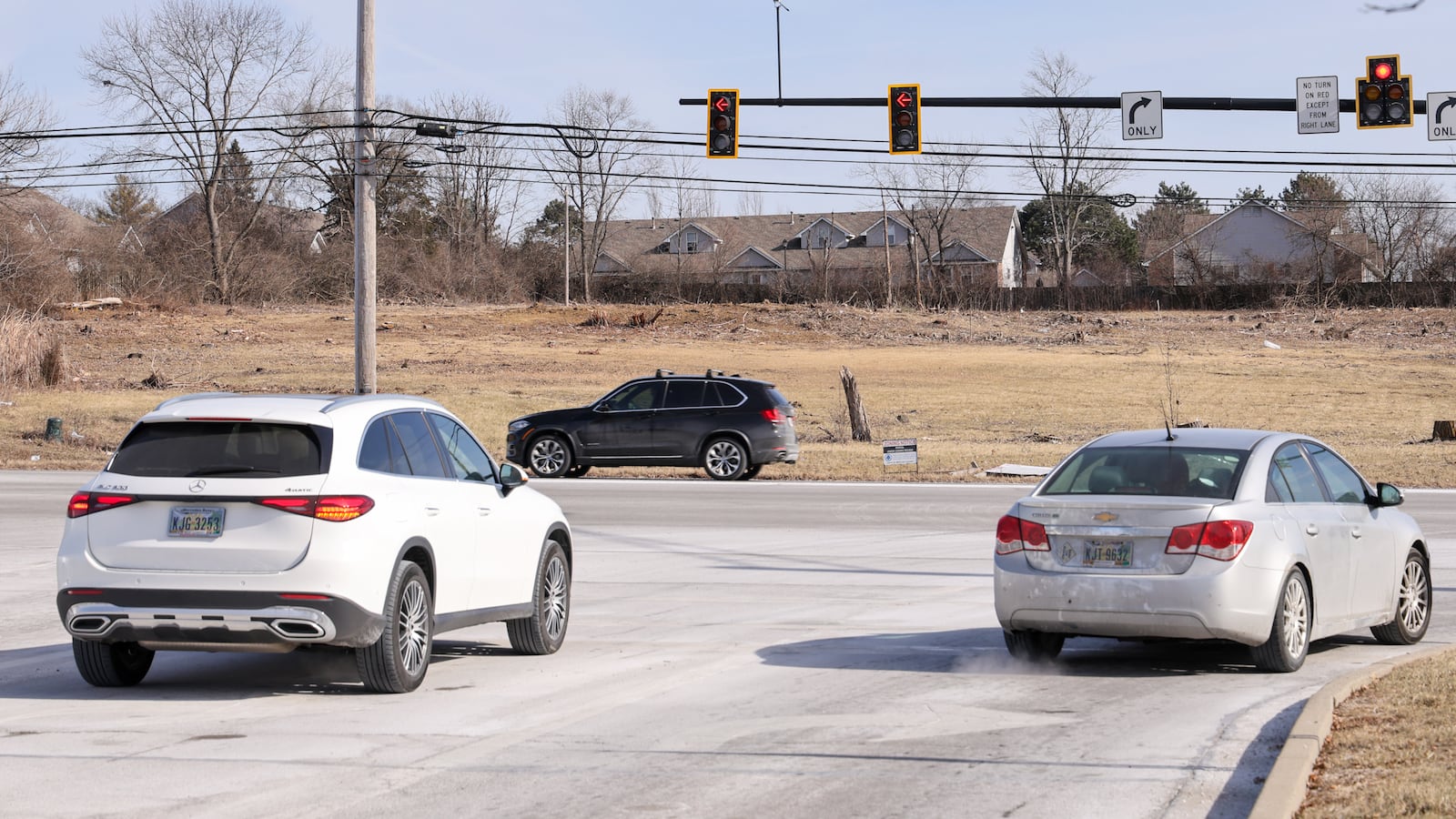 Cars wait to turn onto North Springboro Pike as they exit Austin Landing on Friday, Jan. 23. A new development called Austin Crossing is being built across North Springboro Spike from Austin Landing. BRYANT BILLING/STAFF