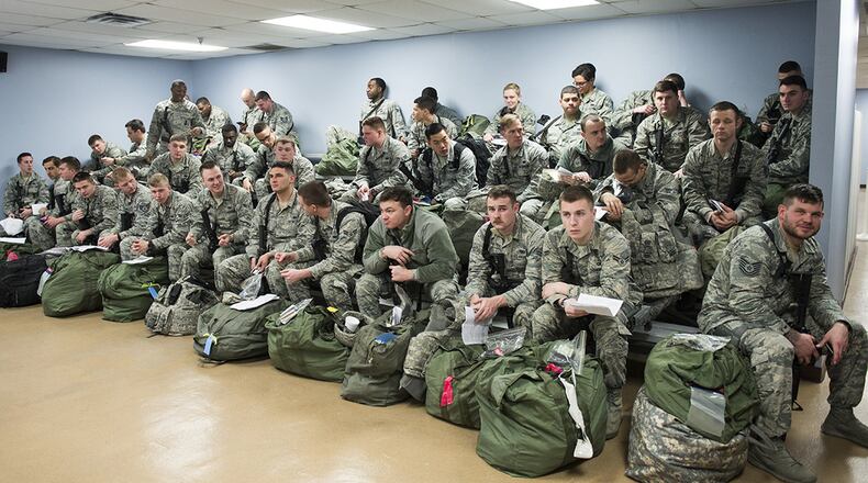 Service members wait on bleachers for their turn to process the deployment line during a base exercise at Wright-Patterson Air Force Base Jan. 29, 2018. (U.S. Air Force photo/Wesley Farnsworth)