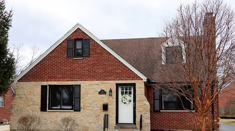 The brick-and-stone home has about 1,610 sq. ft. of living space. The house sits well off the road with a tailored yard and extra parking pad from the side driveway that leads to the 2-car garage with new insulated overhead door. CONTRIBUTED PHOTO BY KATHY TYLER