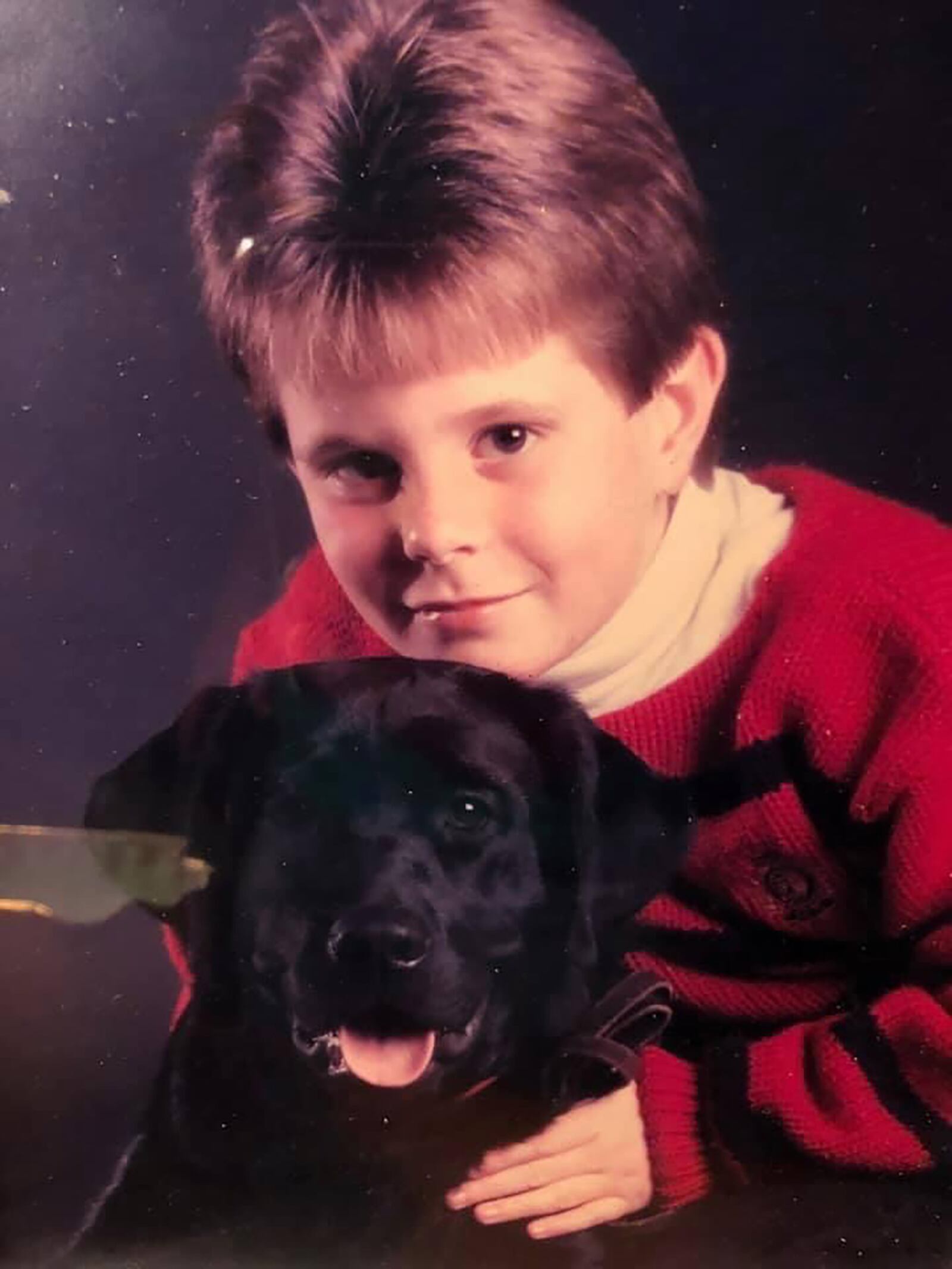 Omer in 1988 with his first dog, Webber. He describes the black lab, a gift for his 8th birthday, as the first love of his life. CONTRIBUTED