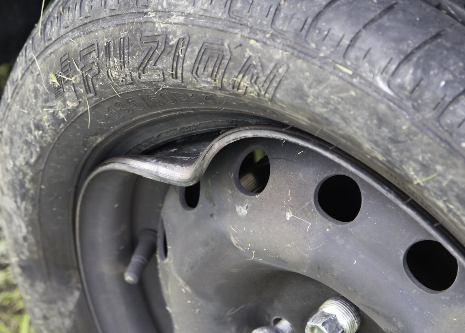 A deep pothole in Kettering got the best of rim on Michael Ligon’s car Friday. The Miamisburg man was one of up to eight drivers whose cars were damaged after hitting the pothole on Arbor Boulevard during the evening rush. CHRIS STEWART / STAFF