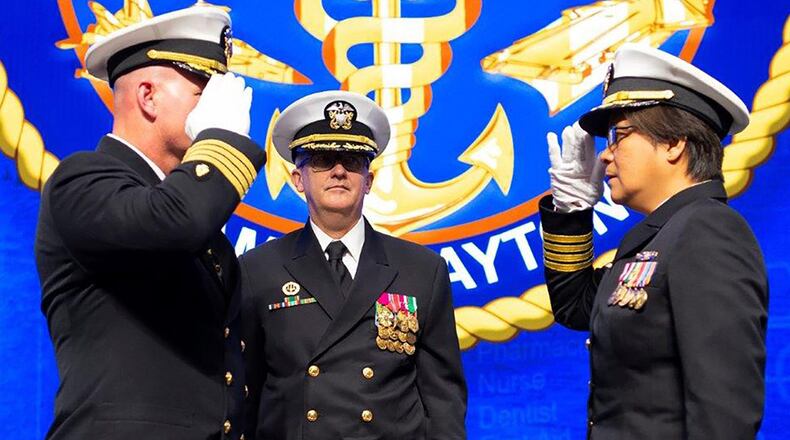 Capt. Adam Armstrong, commander, Naval Medical Research Center relieves Capt. Matthew Hebert from his role of NAMRU-Dayton’s commanding officer and turns command over to Capt. Nimfa Teneza-Mora during change of command ceremony. (U.S. Air Force photo/R.J. Oriez)