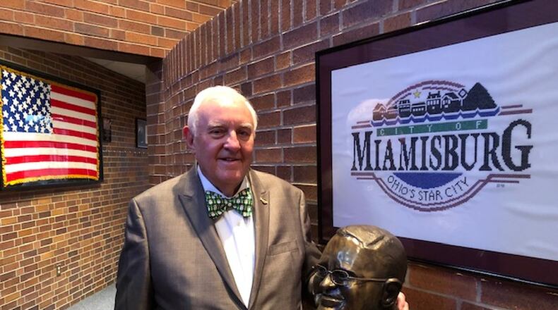 Miamisburg Mayor Dick Church Jr. stands in city council chambers next to a bust of him. Church will be ending his seven-term run as mayor when he retires at the end of the month. NICK BLIZZARD
