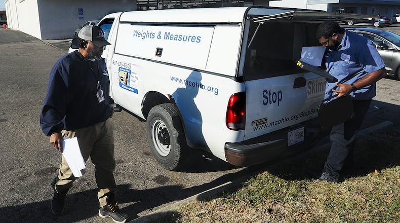 Montgomery County Auditor's Office chief inspector Joseph Harris, left, and inspector Brandon Ladson, right, prepares to inspect a local dollar store on Tuesday, Nov. 22, 2022. MARSHALL GORBY\STAFF