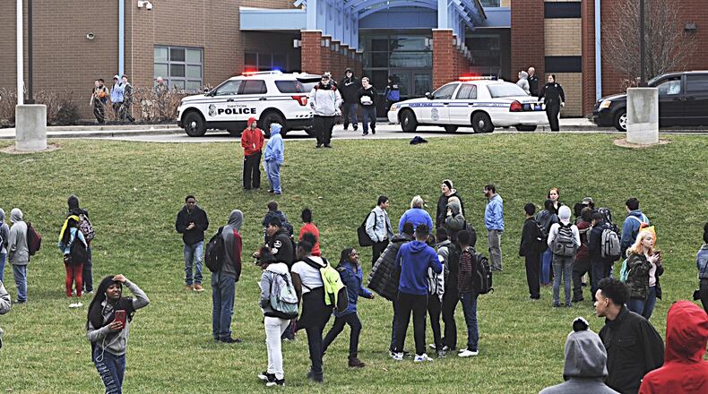 Many Belmont High School students evacuated the building in Dayton last week after rumors circulated that another student was inside with a gun. Police said a student had made threats but took him into custody earlier that day away from school. MARSHALL GORBY / STAFF