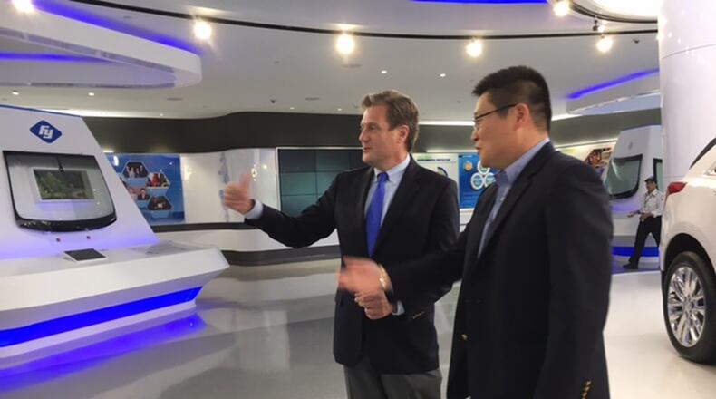 U.S. Rep Mike Turner, R-Dayton, left, with Jeff Liu, president of Fuyao Glass America, as Turner visited Fuyao’s Moraine plant Thursday. THOMAS GNAU/STAFF