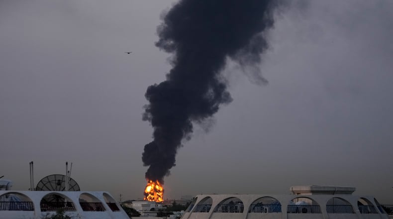 Fire and plumes of smoke rise after a drone struck a fuel tank forcing the temporary suspension of flights. near Dubai International Airport, in United Arab Emirates, early Monday, March 16, 2026. (AP Photo)