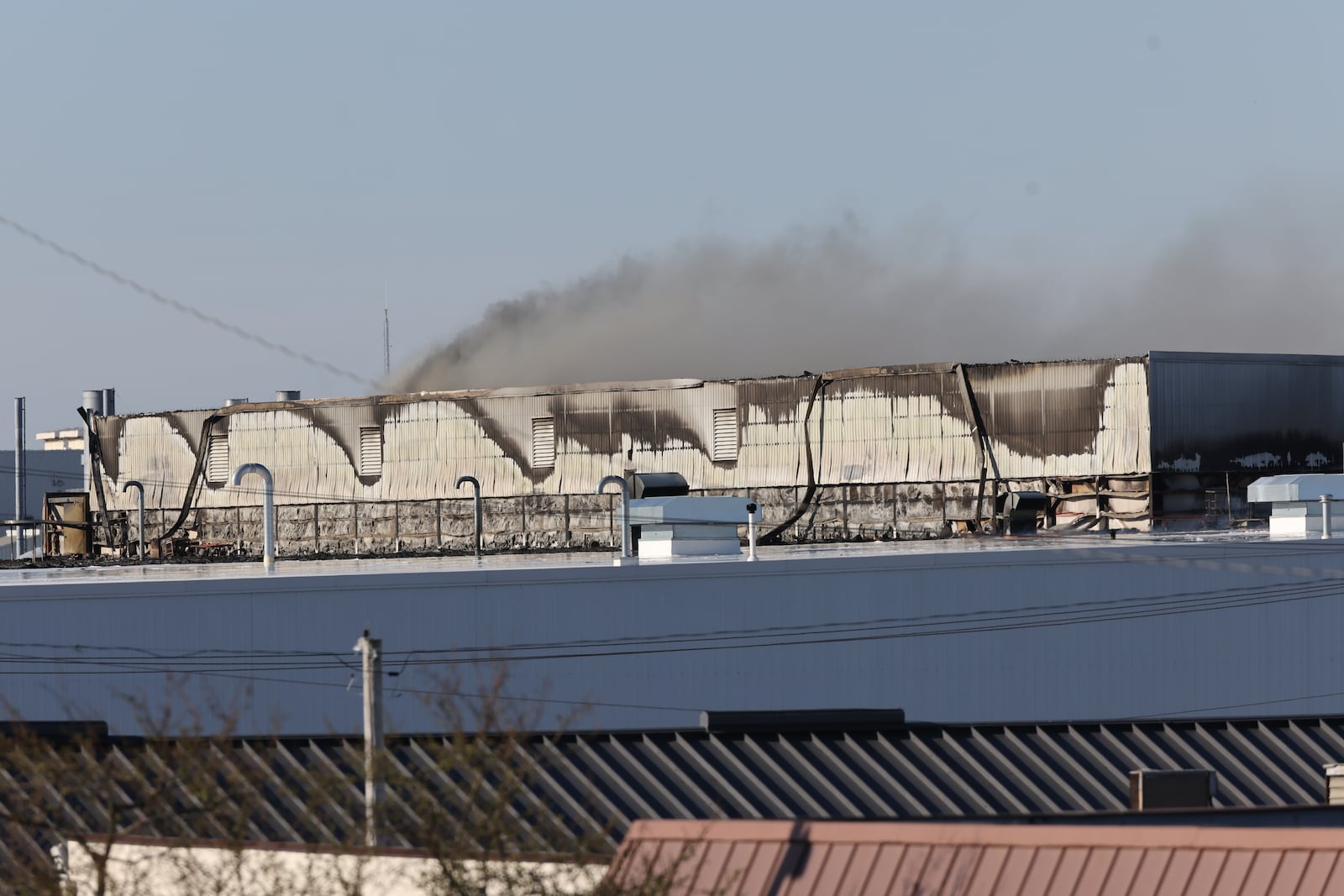 Firefighters continued to battle the remnants of a huge fire at the Fuyao Glass America plant in Moraine on Tuesday, March 24, 2026. The fire first started on Sunday and could be seen for miles originally. BRYANT BILLING / STAFF
