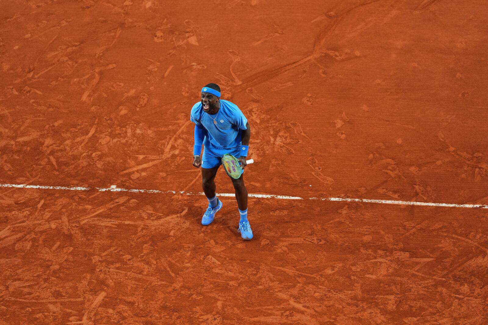 Frances Tiafoe of the U.S. celebrates beating Germany's Daniel Altmaier during their fourth round match of the French Tennis Open, at the Roland-Garros stadium, in Paris, Sunday, June 1 2025. (AP Photo/Lindsey Wasson)