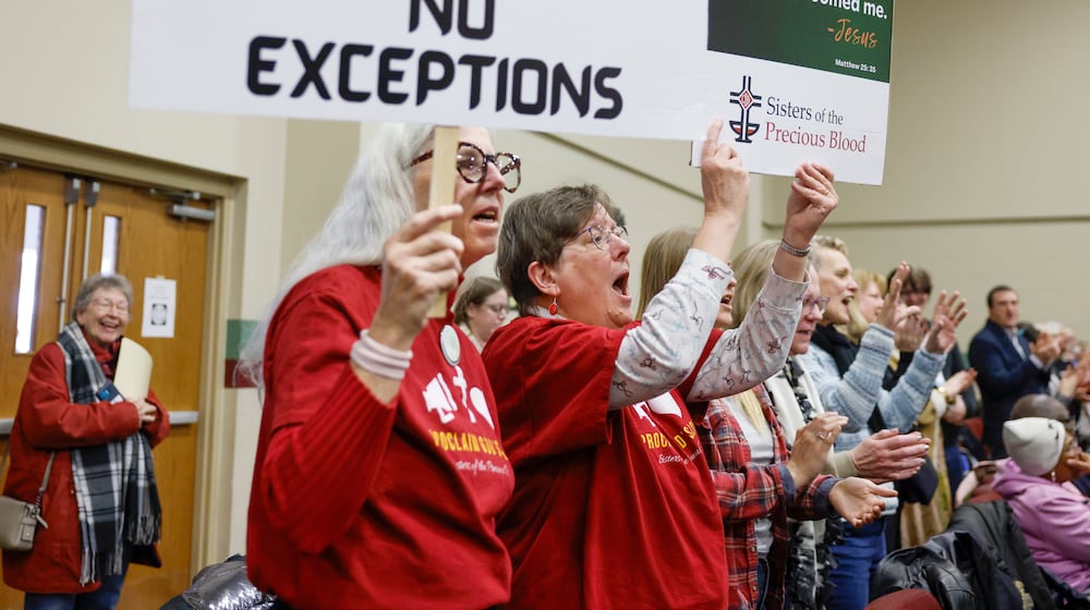 Audience members sing along to praise songs and hold pro-immigration signs during Here We Stand: Faith Leaders for Immigration Justice & Family Unity at St. John Missionary Baptist Church on Monday, Feb. 2, 2026, in Springfield. Pastors, faith leaders and community members gathered to pray and call for the extension of Temporary Protected Status which is scheduled to expire on Tuesday, Feb. 3, 2026. JOSEPH COOKE/STAFF