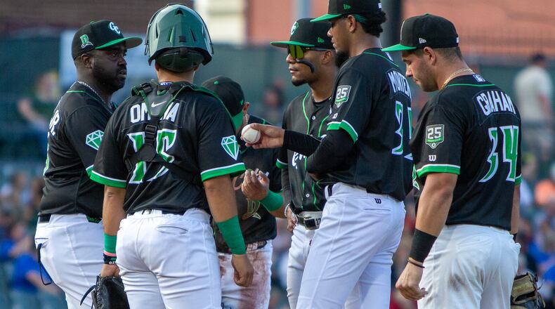 Dragons manager Vince Harrison Jr. takes the ball from starter Jose Montero in the third inning Thursday night at Day Air Ballpark. Montero allowed five runs and took the loss. Jeff Gilbert/CONTRIBUTED