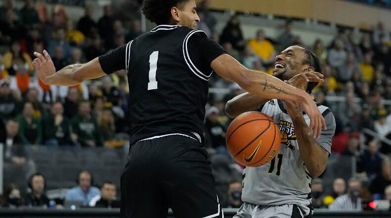 Northern Kentucky's Bryson Langdon (11) has the basketball stripped by Wright State's Trey Calvin (1) during the first half of an NCAA college basketball game for the Horizon League men's tournament championship Tuesday, March 8, 2022, in Indianapolis. (AP Photo/Darron Cummings)