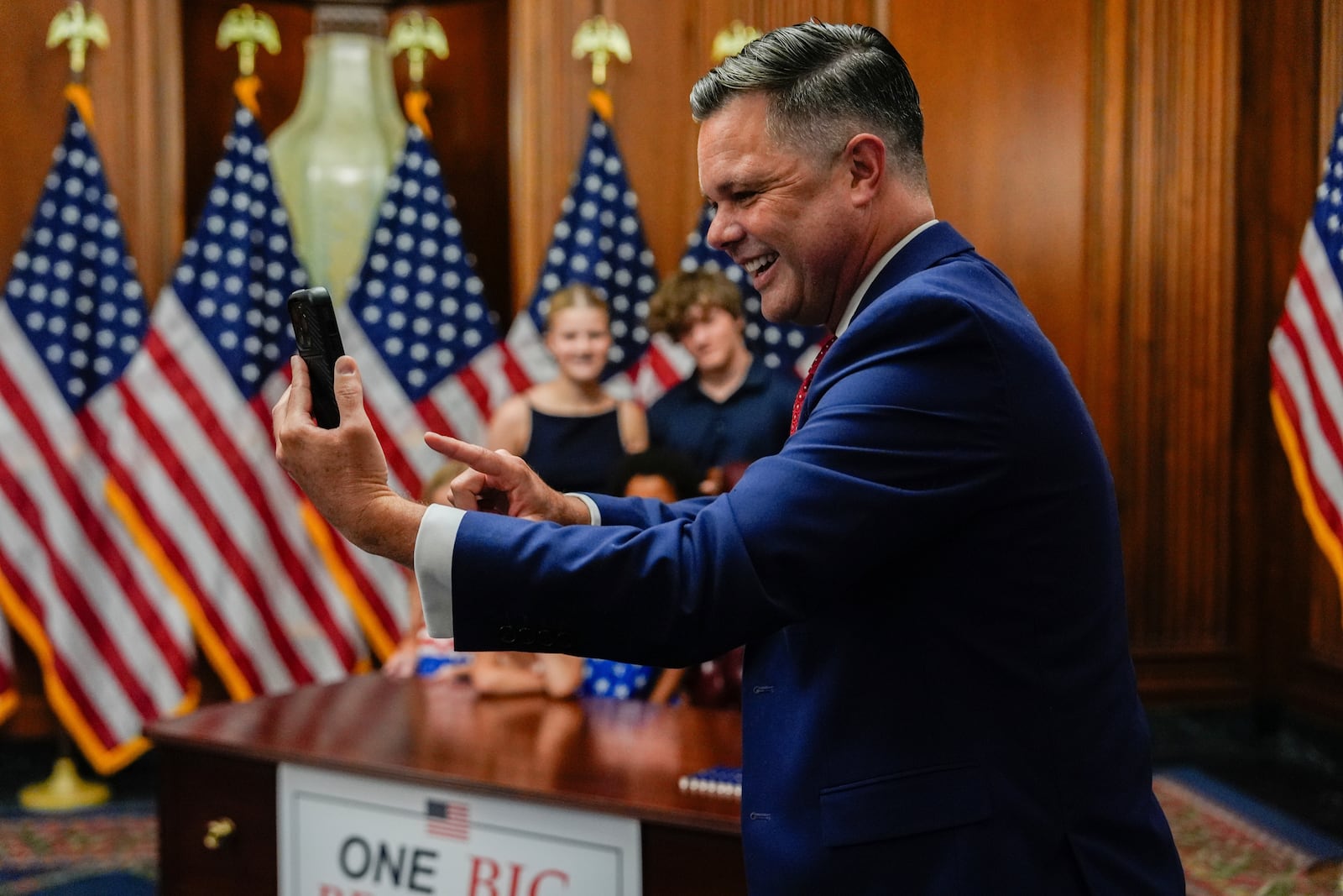 Rep. Zach Nunn, R-Iowa, takes a selfie following the passage of President Donald Trump's signature bill of tax breaks and spending cuts, Thursday, July 3, 2025, at the Capitol in Washington. (AP Photo/Julia Demaree Nikhinson)
