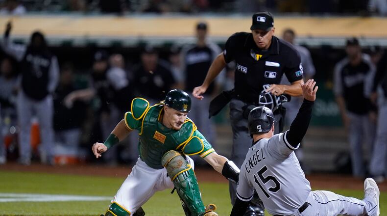 FILE - Oakland Athletics catcher Sean Murphy, left, tries to tag Chicago White Sox's Adam Engel (15), who scored the tying run during the ninth inning of a baseball game in Oakland, Calif., Sept. 9, 2022. The Atlanta Braves acquired catcher Murphy from the Oakland Athletics as part of a three-team deal on Monday, Dec. 12, 2022, that also sent catcher William Contreras to the Milwaukee Brewers. (AP Photo/Godofredo A. Vásquez, File)