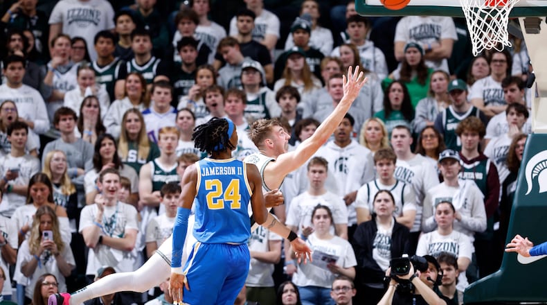 Michigan State center Carson Cooper, rear, shoots against UCLA center Steven Jamerson II (24) during the first half of an NCAA college basketball game, Tuesday, Feb. 17, 2026, in East Lansing, Mich. (AP Photo/Al Goldis)