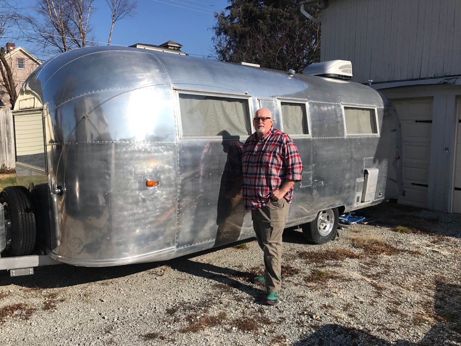 Wrongly imprisoned Dean Gillispie next to the 1963 Airstream trailer he completely rebuilt. Miami Twp. officials say they simply can’t pay the $45 million judgment against the township even if they cut every service they can for today’s township residents. Tom Archdeacon/CONTRIBUTED