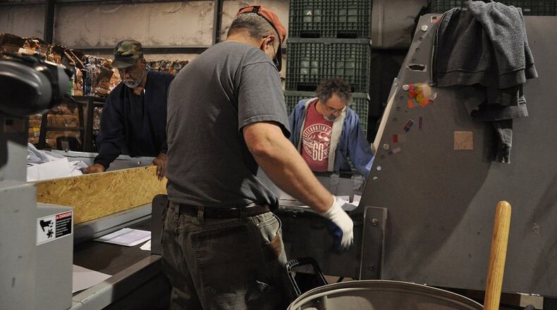 Thom Doucette, operations manager and tour guide for America Recycles Day Nov 15, stands in front of 24 pallets of recycled toner cartridges ready to be shipped out of Wright-Patterson Air Force Base to be repurposed. (U.S. Air Force photo/W. Eugene Barnett)