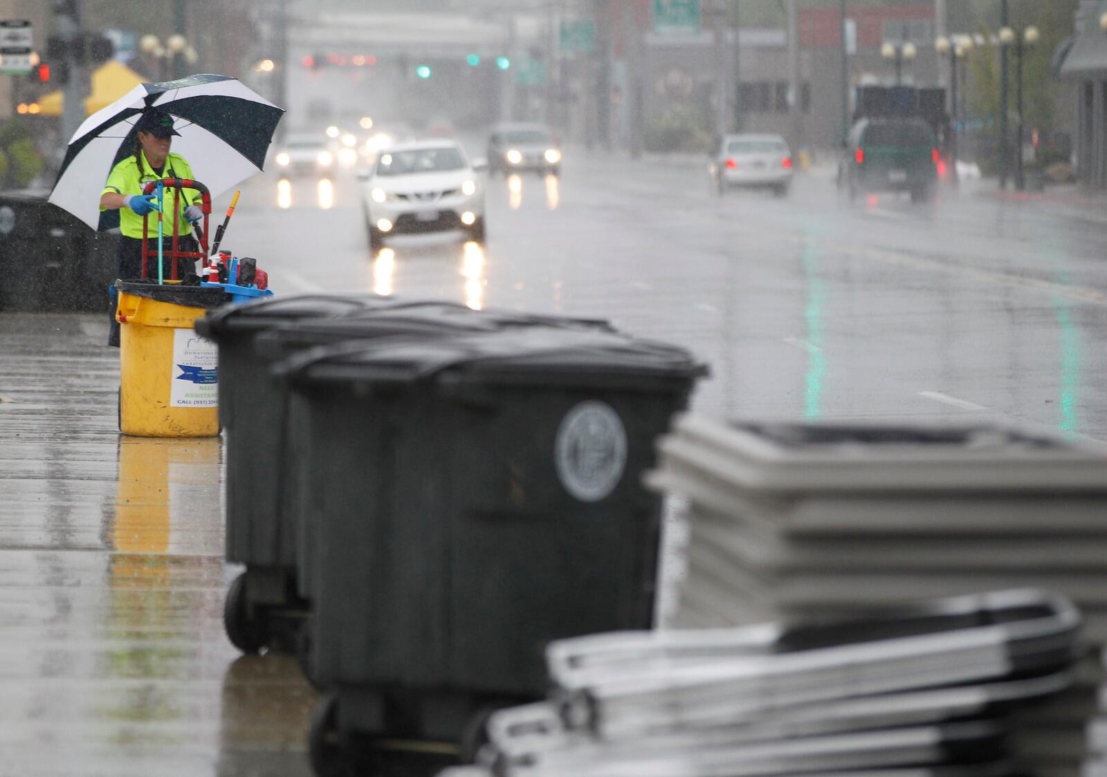 A downtown Dayton ambassador helps remove trash from Wayne Avenue in downtown Dayton. STAFF