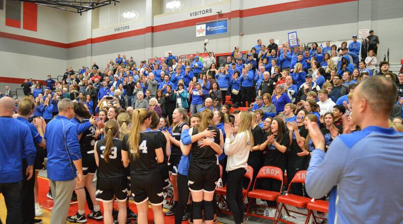 Springboro’s girls basketball team celebrates an emotional 53-50 win over Centerville on Monday night at Troy High School. Eric Frantz/CONTRIBUTED