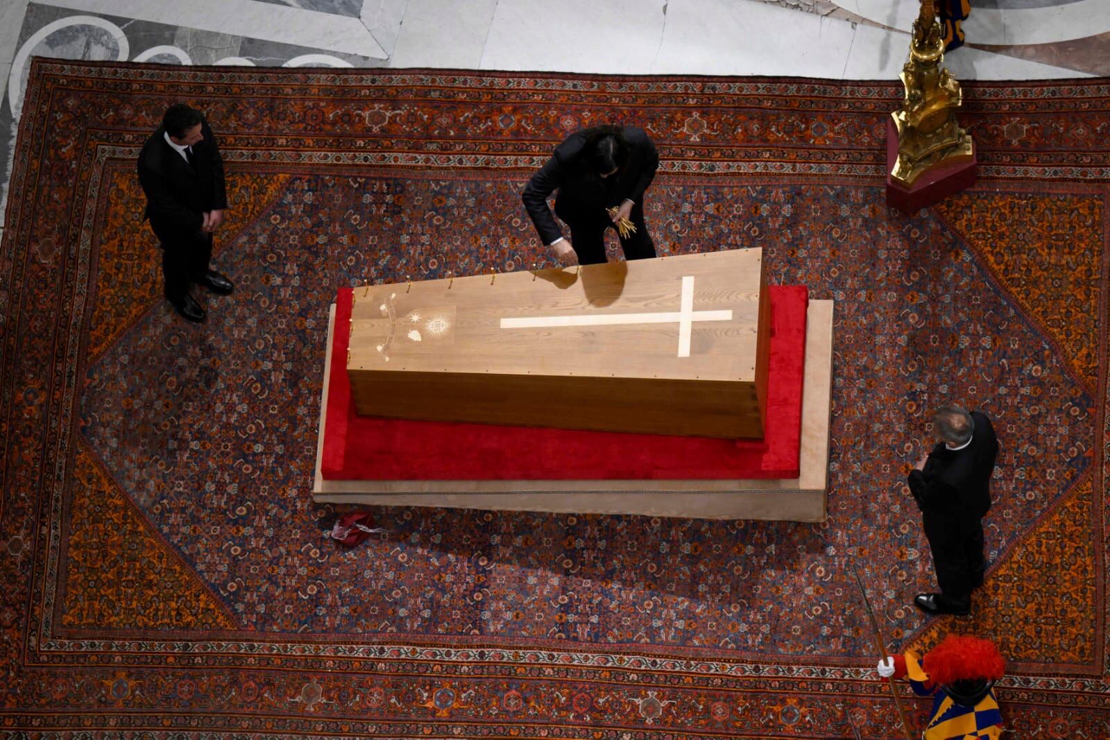 Cerimonial ushers close the casket containing the body of Pope Francis in St. Peter's Basilica at the Vatican Friday, April 25, 2025. (Vatican Media via AP)