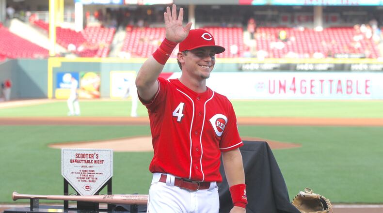 The Redsâ Scooter Gennett waves to the crowd during a pregame ceremony honoring him before a game against the Dodgers on Friday, June 16, 2017, at Great American Ball Park in Cincinnati. David Jablonski/Staff