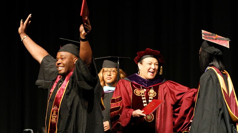 FILE: About 240 Central State University graduates received degrees Saturday, May 6, at the 2017 Central State University Commencement at the Dayton Convention Center. University President Cynthia Jackson-Hammond, center, presents diplomas. CHRIS STEWART / STAFF