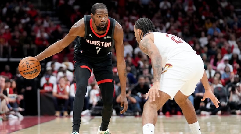 Houston Rockets forward Kevin Durant (7) dribbles as Cleveland Cavaliers guard Jaylon Tyson defends during the first half of an NBA basketball game, Saturday, Dec. 27, 2025, in Houston. (AP Photo/Eric Christian Smith)