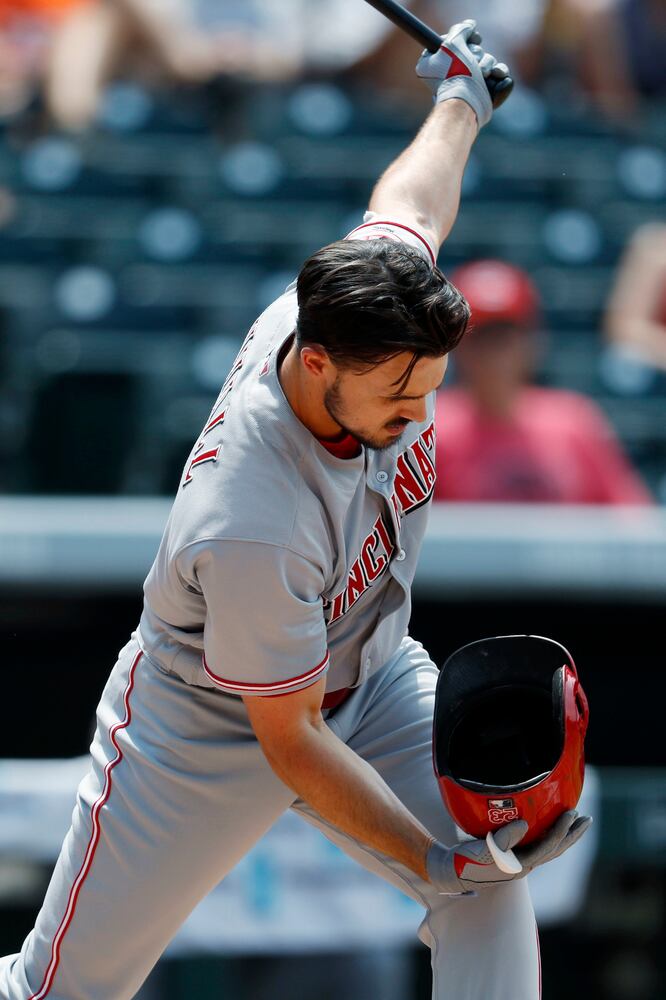 PHOTOS: Reds pile up 13 hits, beat the Rockies
