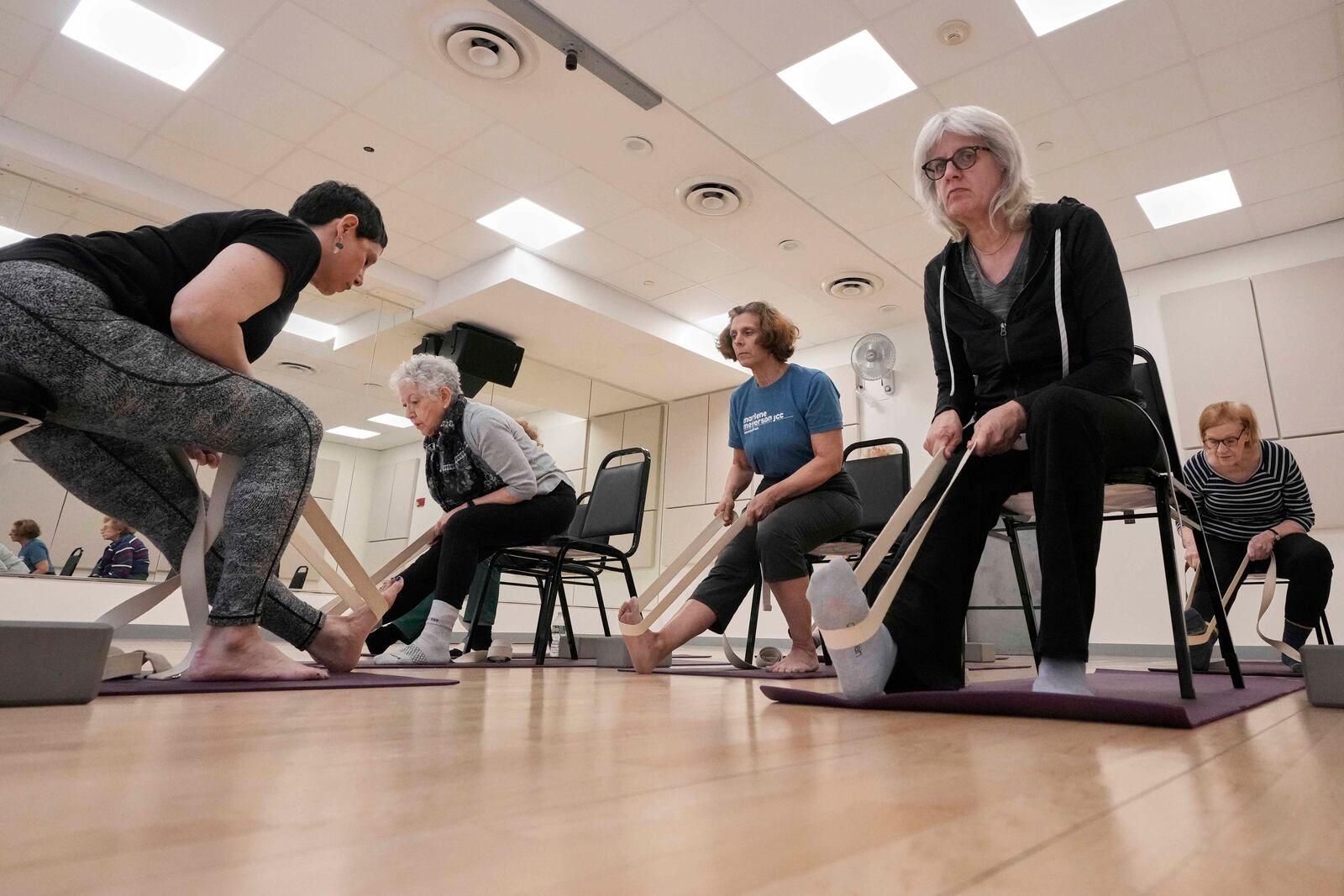 Whitney Chapman, left, conducts a chair yoga class at the Marlene Meyerson JCC Manhattan, in New York, March 28, 2025. (AP Photo/Richard Drew)