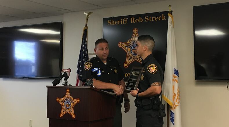 Montgomery County Sheriff Rob Streck presents corrections officer Tyler Viernes with the 2019 Correctional Officer of the Year award. STAFF/BONNIE MEIBERS