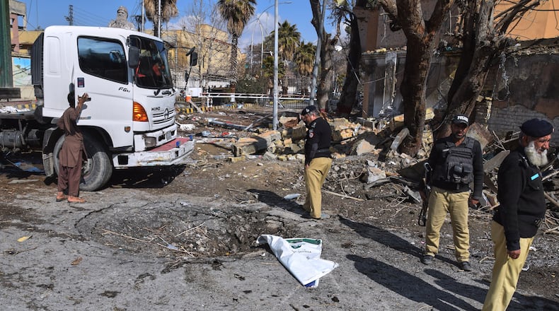 Police officers examine the site of Saturday's suicide bombing, in Quetta, Pakistan, Sunday, Feb. 1, 2026. (AP Photo/Arshad Butt)
