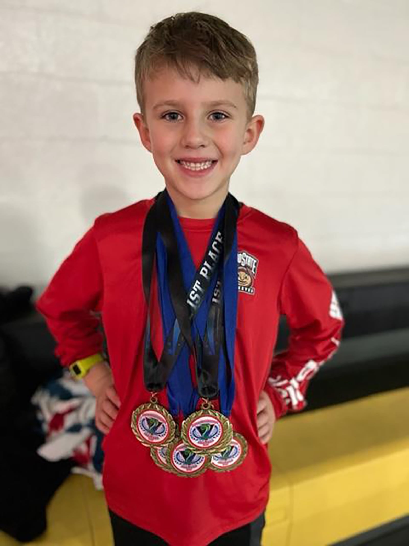 Tyler Gibble showing off a few of his medals received at just six year old. He was already breaking records at that age. CONTRIBUTED