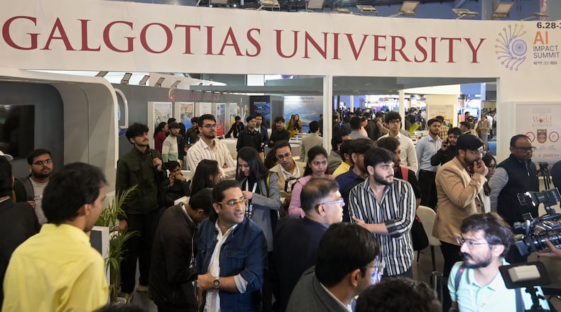 People visit Galgotias University stall at AI summit ahead of an eviction order issued by Indian authorities, in New Delhi, India, Wednesday, Feb. 18, 2026. (AP Photo)