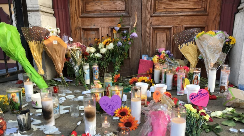Memorials like this one in front of Ned Peppers bar have popped up in the Oregon District, one day removed from a mass shooting that killed nine victims and one shooter. (Bonnie Meibers/Staff)