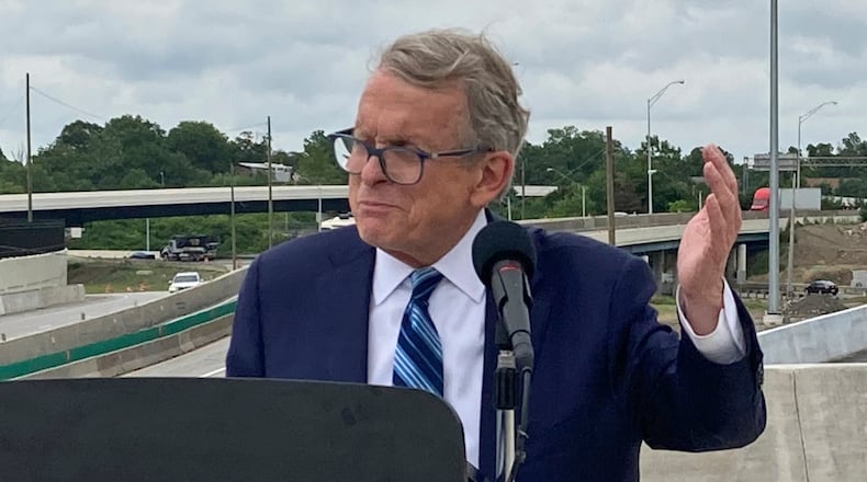 FILE - In this July 13, 2021 file photo, Ohio Gov. Mike DeWine promotes a new entrance ramp onto I-70 in Columbus, Ohio. A political stalemate over Ohio’s new legislative maps has plunged the state into confusion. As members of a new map-drawing commission defended themselves against potential contempt charges for failing to meet the latest court order requiring them to stop gerrymandering, top leaders were urging lawmakers to delay the May 3 primary. The bipartisan Ohio Redistricting Commission planned to meet again Wednesday, Feb. 23, 2022 and Thursday. (AP Photo/Andrew Welsh-Huggins, File)