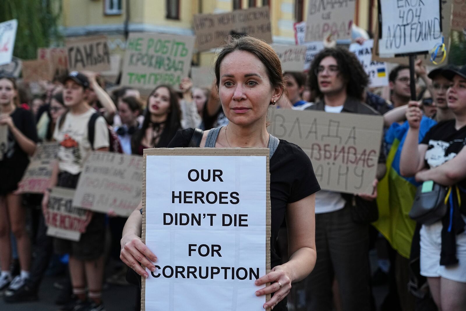 A woman holds a banner during a protest against a law targeting anti-corruption institutions in central Kyiv, Ukraine, Wednesday, July 23, 2025. (AP Photo/Efrem Lukatsky)