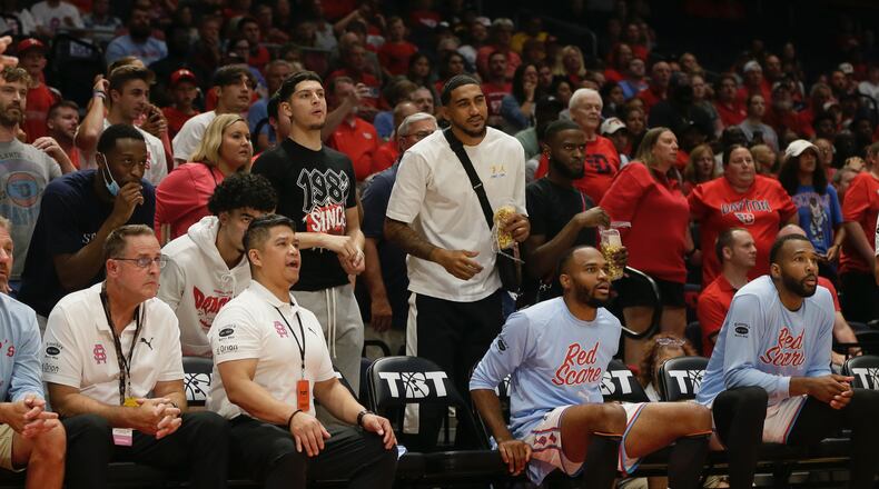 Obi Toppin and Jalen Crutcher and several current Dayton players watch from behind the bench during a game between the Red Scare and the Golden Eagles in The Basketball Tournament on Wednesday, July 27, 2022, at UD Arena. David Jablonski/Staff