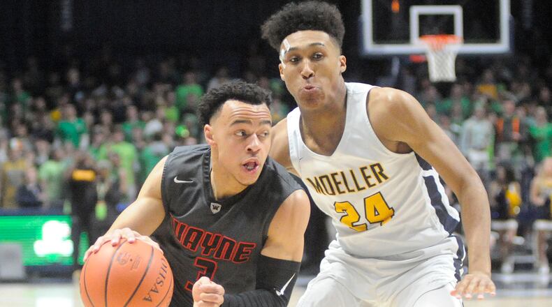 Wayne’s Darius Quisenberry (with ball) and Moeller’s Jeremiah Davenport, a Wright State recruit, were matched against each other. Moeller defeated Wayne 65-53 in a boys high school basketball D-I regional final at Xavier University Cintas Center in Cincinnati on Friday, March 16, 2018. MARC PENDLETON / STAFF