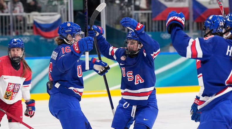 United States' Hayley Scamurra, left, celebrates with teammates after scoring her sides fifth goal during a preliminary round match of women's ice hockey between United States and Czechia at the 2026 Winter Olympics, in Milan, Italy, Thursday, Feb. 5, 2026. (AP Photo/Petr David Josek)