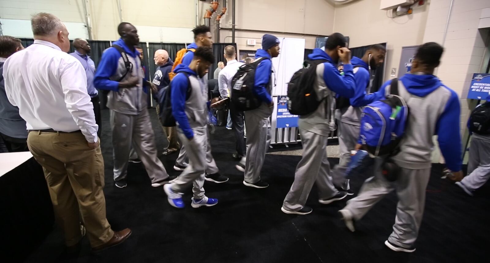 New Orleans Basketball team enters the team check-in area which has been carpeted and converted from a loading dock at UD Arena.  TY GREENLEES / STAFF