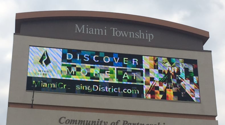A digital billboard at the Dayton Mall is one of several ways the Miami Crossing District in the area around the mall is being promoted. NICK BLIZZARD/STAFF