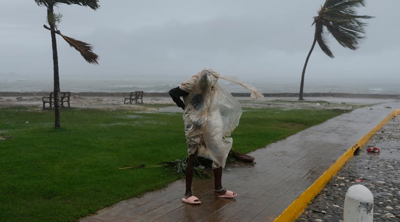 A man walks in Kingston, Jamaica, as Hurricane Melissa approaches, Tuesday, Oct. 28, 2025. (AP Photo/Matias Delacroix)