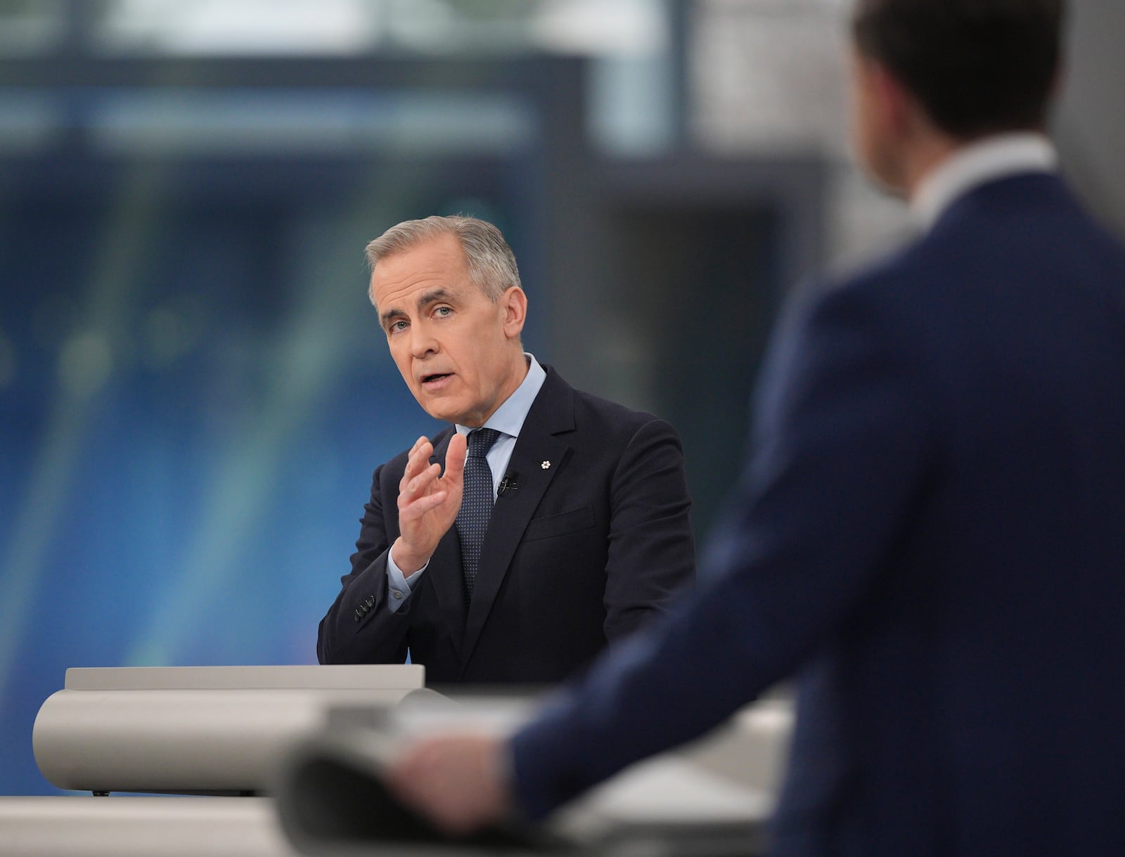 Liberal Leader Mark Carney makes a point towards Conservative Leader Pierre Poilievre during the French-language federal leaders' debate in Montreal, Wednesday, April 16, 2025. (Christopher Katsarov/The Canadian Press via AP)