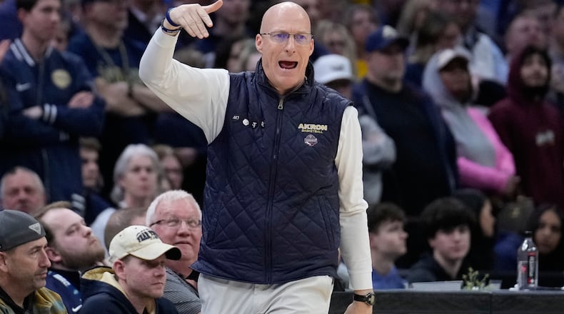 Akron head coach John Groce gestures in the second half of a basketball game against Kent State in the semifinals of the Mid-American Conference tournament, Friday, March 13, 2026, in Cleveland. (AP Photo/Sue Ogrocki)