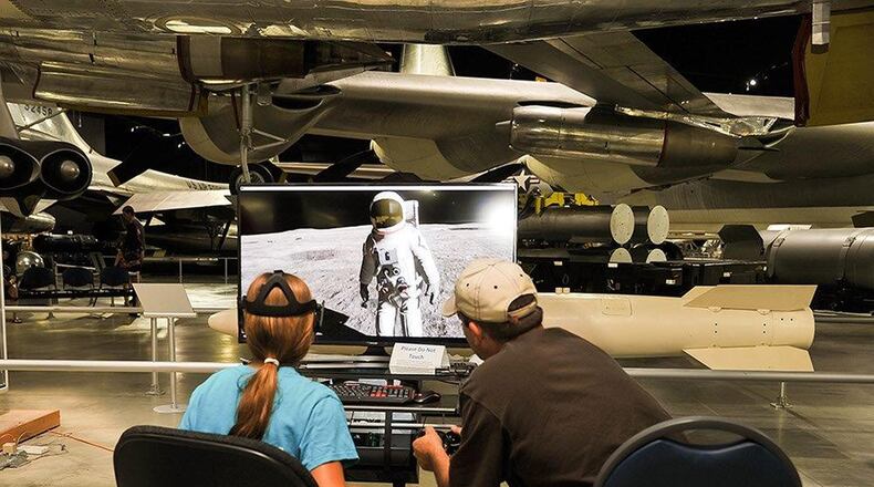 National Museum of the U.S. Air Force exhibits specialist Kirk Thompson, right, helps museum guest Laci Delauder walk on the moon on July 20 with the virtual reality exhibit Oculus Rift. The exhibit was part of the family day activities honoring the 50th anniversary of the Apollo 11 moon landing. (U.S. Air Force photo/Pamela Piccoli)