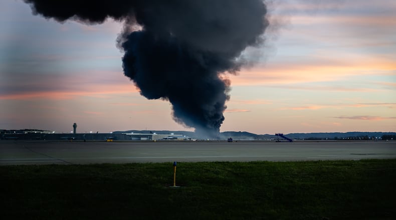 A plume of smoke rises from the site of a UPS cargo plane crash at Louisville Muhammad Ali International Airport on Tuesday, Nov. 4, 2025, in Louisville, Ky. (AP Photo/Jon Cherry)