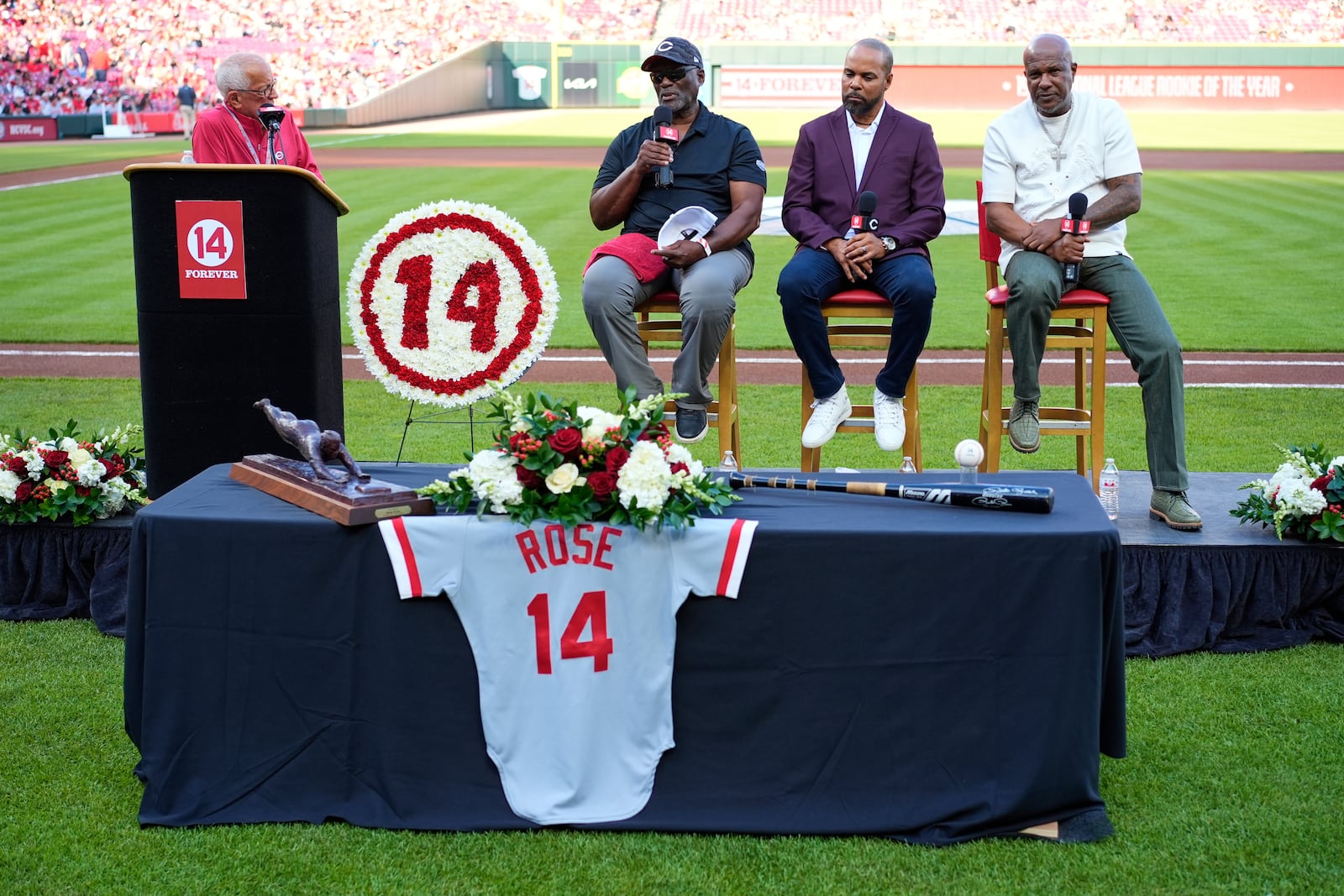 Cincinnati Reds broadcaster Marty Brennaman, left, introduces Reds Hall of Fame players, left to right, George Foster, Barry Larkin and Eric Davis for Pete Rose Night events before a baseball game between the Cincinnati Reds and the Chicago White Sox, Wednesday, May 14, 2025, in Cincinnati. (AP Photo/Carolyn Kaster)