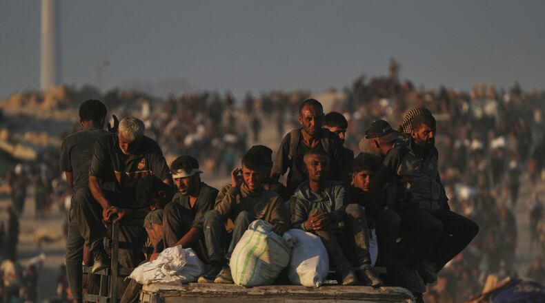FILE - Palestinians carry sacks of flour unloaded from a humanitarian aid convoy that reached Gaza City from the northern Gaza Strip, Sunday, Aug. 24, 2025. (AP Photo/Abdel Kareem Hana, File)